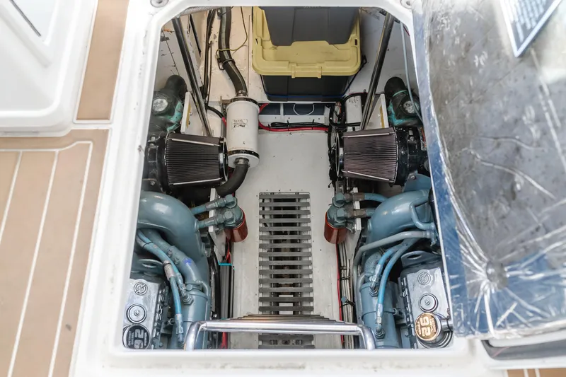 Slide: The Image of Engine compartment of a 1996 Tiara Yachts 4300, showcasing dual engines and mechanical components. - 44