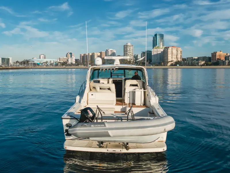 Slide: The Image of 1996 Tiara Yachts 4300 on calm water with city skyline in background. - 8