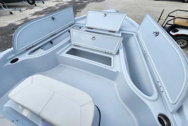 Slide: The Image of 2024 Blue Wave 2000 Classic boat interior with open storage compartments and seating. - 12
