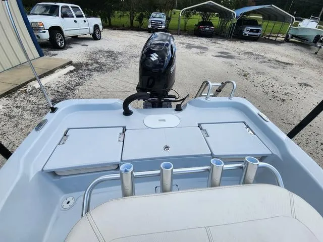 Slide: The Image of 2024 Blue Wave 2000 Classic boat with Suzuki outboard motor, parked in a lot. - 16