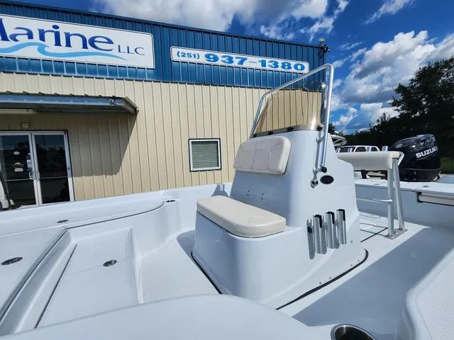 Slide: The Image of 2024 Blue Wave 2000 Classic boat at dealership, clear sky, outdoor display. - 4