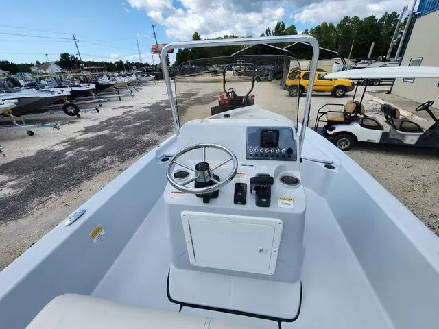 Slide: The Image of 2024 Blue Wave 2000 Classic boat interior with steering wheel and control panel. - 7
