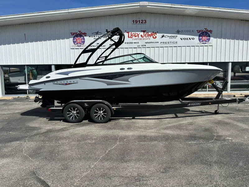 The Image of 2025 Monterey M22 boat on trailer outside dealership. - 1