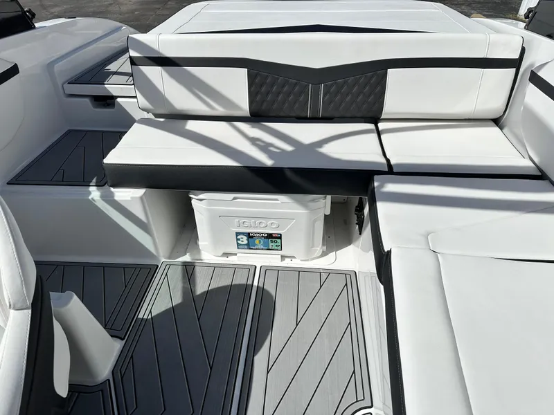 Slide: The Image of 2025 Monterey M22 boat interior with white seating and integrated cooler. - 10