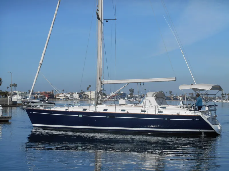 Slide: The Image of 2000 Beneteau Oceanis 50 sailboat docked in a marina under clear blue skies. - 12