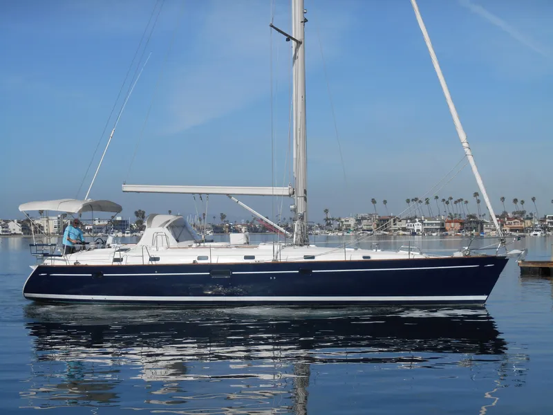 Slide: The Image of 2000 Beneteau Oceanis 50 sailboat on calm water, clear sky background. - 16