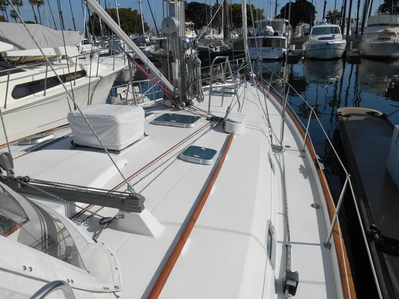 Slide: The Image of Beneteau Oceanis 50 sailboat, 2000 model, docked in a marina with clear skies. - 17