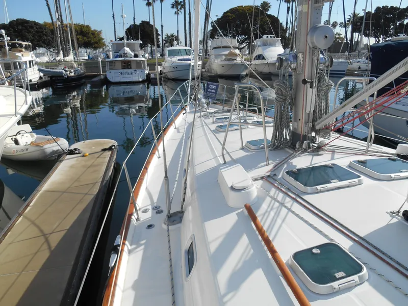 Slide: The Image of Beneteau Oceanis 50 sailboat docked in marina, showcasing deck and rigging, year 2000 model. - 2