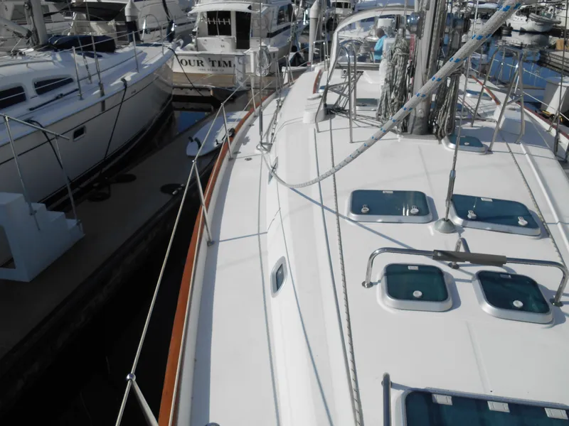 Slide: The Image of Beneteau Oceanis 50 sailboat, 2000 model, docked in a marina, showcasing deck and rigging. - 20