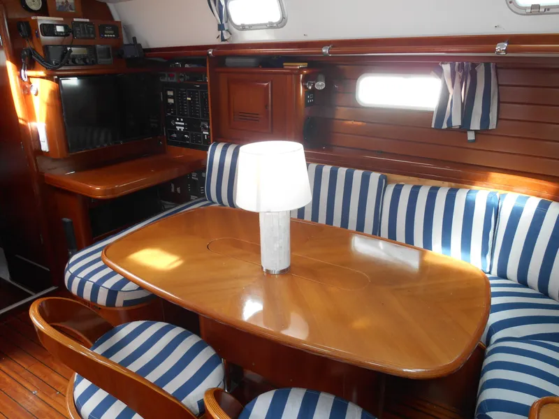 Slide: The Image of Interior of 2000 Beneteau Oceanis 50 yacht with striped seating and wooden table. - 24
