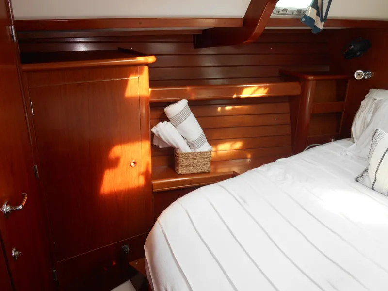 Slide: The Image of Cozy cabin interior of 2000 Beneteau Oceanis 50 yacht with wooden paneling and bed. - 36