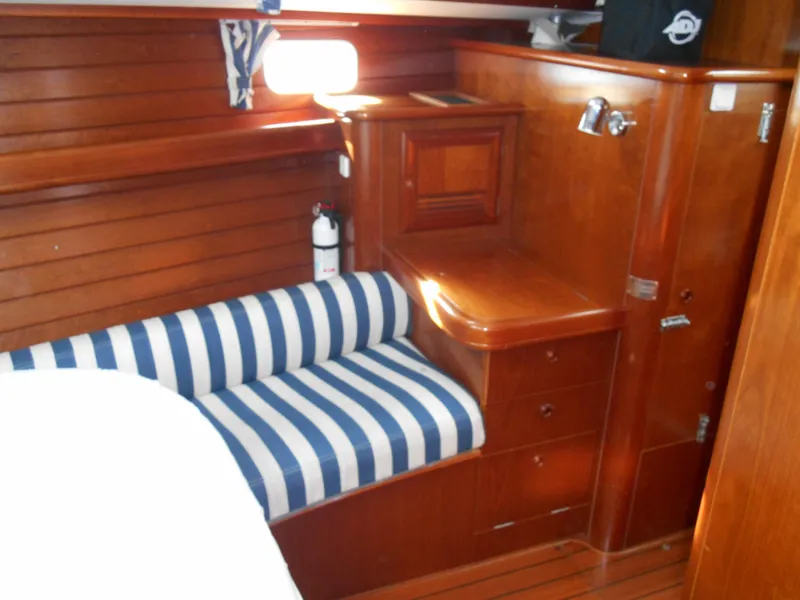 Slide: The Image of Interior of 2000 Beneteau Oceanis 50 yacht with striped seating and wooden cabinetry. - 37