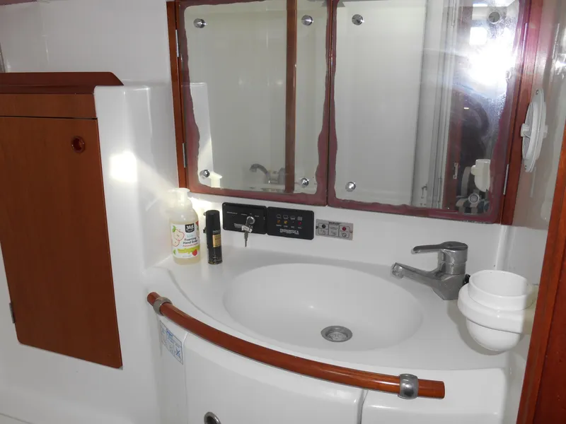 Slide: The Image of Beneteau Oceanis 50 bathroom with sink, mirror, and wooden cabinetry, year 2000 model. - 38