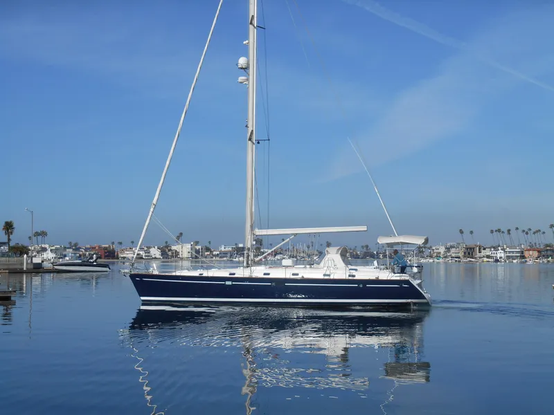 Slide: The Image of Beneteau Oceanis 50 sailboat from 2000 on calm water, clear sky background. - 4