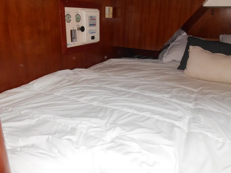 Slide: The Image of Cozy cabin bed in 2000 Beneteau Oceanis 50 sailboat with control panel. - 41