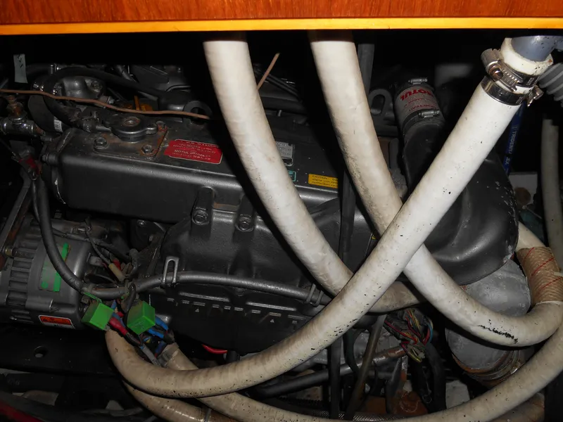 Slide: The Image of Engine compartment of a 2000 Beneteau Oceanis 50 sailboat with visible hoses and components. - 43