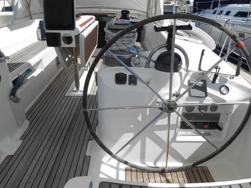 Slide: The Image of Steering wheel of a 2000 Beneteau Oceanis 50 sailboat with wooden deck. - 46