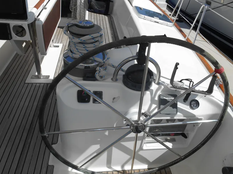 Slide: The Image of Steering wheel of a 2000 Beneteau Oceanis 50 sailboat, featuring deck equipment and controls. - 48