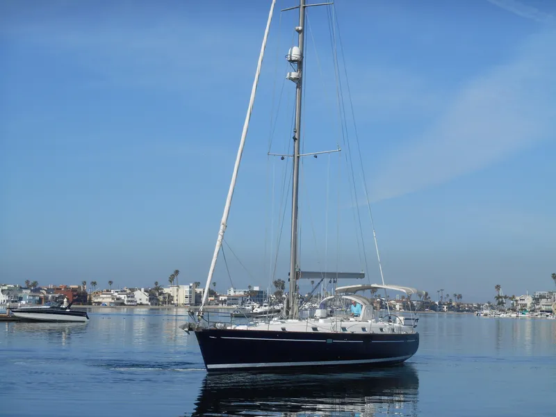 Slide: The Image of Beneteau Oceanis 50 sailboat from 2000 on calm water, clear blue sky. - 7