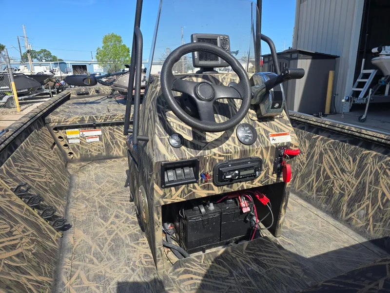Slide: The Image of 2012 Lowe Roughneck 1860CC boat interior with camouflage design and steering console. - 6