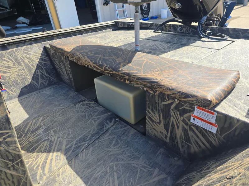 Slide: The Image of 2012 Lowe Roughneck 1860CC boat interior with camouflage seating and storage compartment. - 8