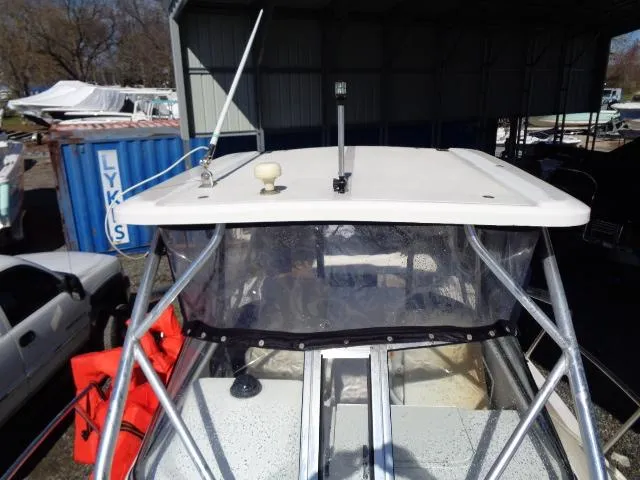 Slide: The Image of 2007 Century 2200 Walkaround boat with canopy and metal frame in storage area. - 10