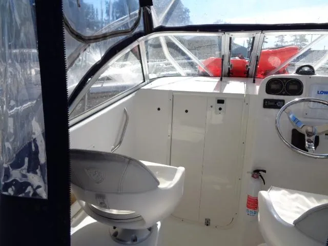 Slide: The Image of 2007 Century 2200 Walkaround boat interior with steering wheel and seating. - 11