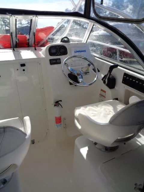 Slide: The Image of 2007 Century 2200 Walkaround boat interior with steering wheel and seating. - 12