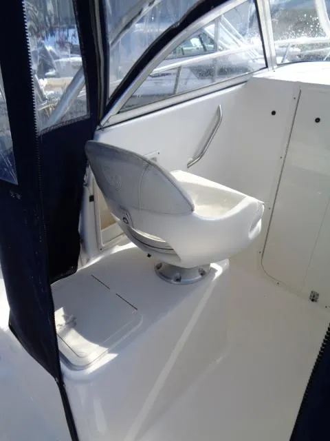Slide: The Image of 2007 Century 2200 Walkaround boat interior with swivel seat and protective canopy. - 14