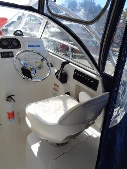 Slide: The Image of 2007 Century 2200 Walkaround boat interior with steering wheel and control panel. - 15