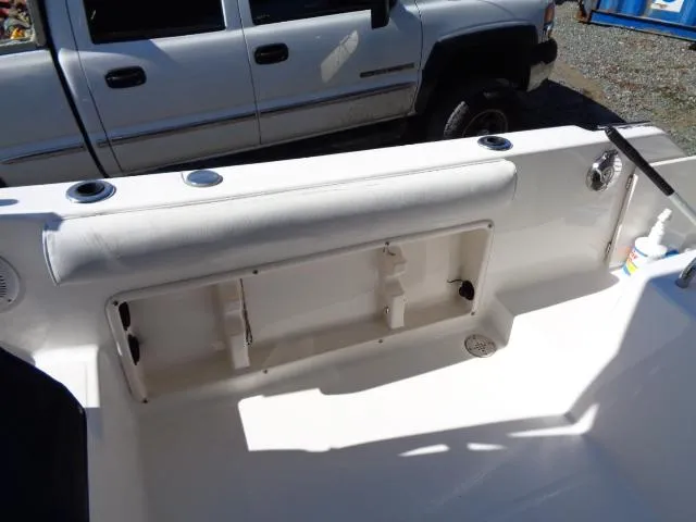 Slide: The Image of 2007 Century 2200 Walkaround boat interior with storage compartment, parked beside a truck. - 17