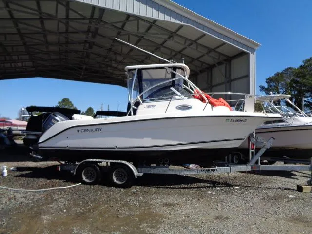 Slide: The Image of 2007 Century 2200 Walkaround boat on trailer under a metal canopy. - 20