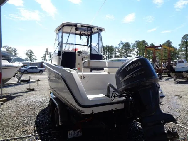 Slide: The Image of 2007 Century 2200 Walkaround boat with Yamaha outboard motor, parked on a trailer. - 4
