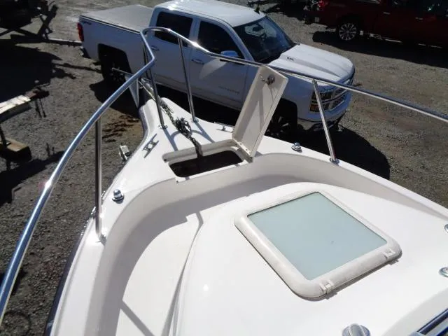 Slide: The Image of 2007 Century 2200 Walkaround boat bow with open hatch, parked near a white pickup truck. - 9