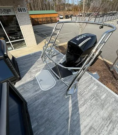 Slide: The Image of 2025 Crest Caribbean 230 boat with modern design and powerful engine, parked outdoors. - 10