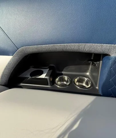 Slide: The Image of 2025 Crest Caribbean 230 interior with cup holders and storage compartment. - 15