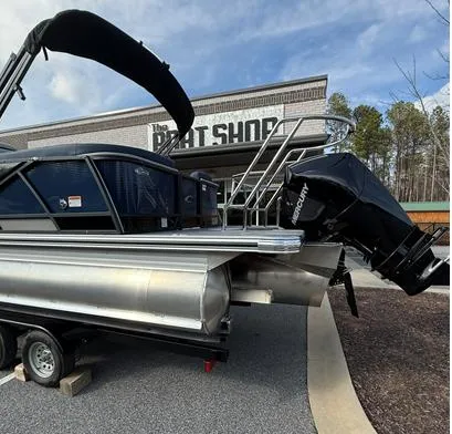 Slide: The Image of 2025 Crest Caribbean 230 boat on trailer outside The Boat Shop. - 2