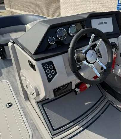 Slide: The Image of 2025 Crest Caribbean 230 boat dashboard with steering wheel and control panel. - 7