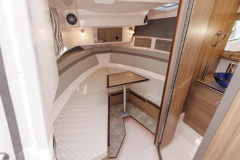 Slide: The Image of Interior of 2025 Solara S-310 SB boat with cozy seating and wooden accents. - 13