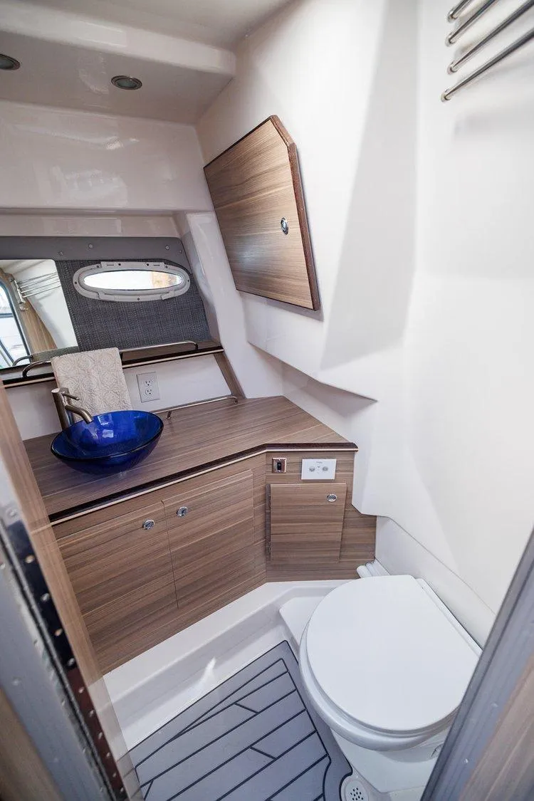 Slide: The Image of 2025 Solara S-310 SB yacht bathroom with modern fixtures and wooden cabinetry. - 14