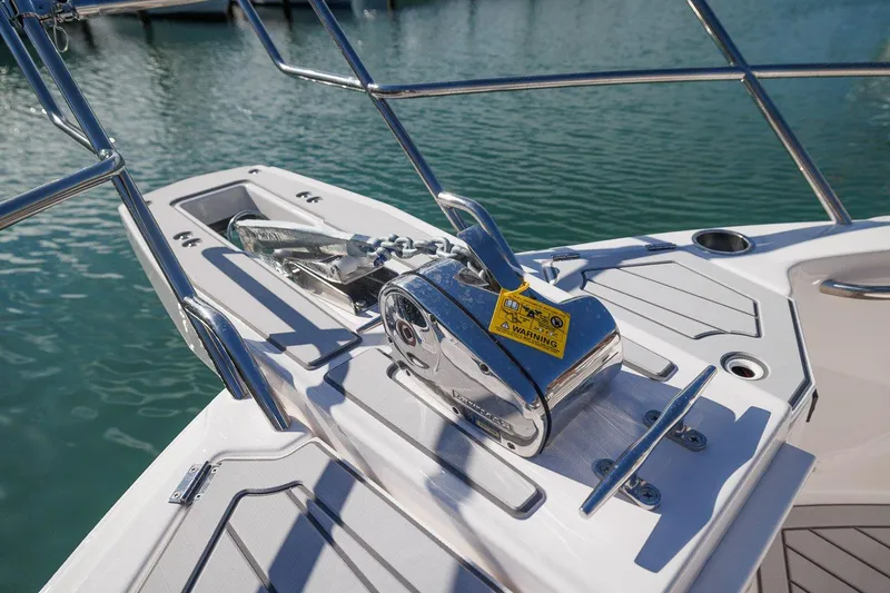 Slide: The Image of 2025 Solara S-310 SB boat anchor system on deck, docked in calm waters. - 20