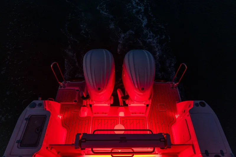 Slide: The Image of Red-lit deck of 2025 Solara S-310 SB boat with dual engines. - 22
