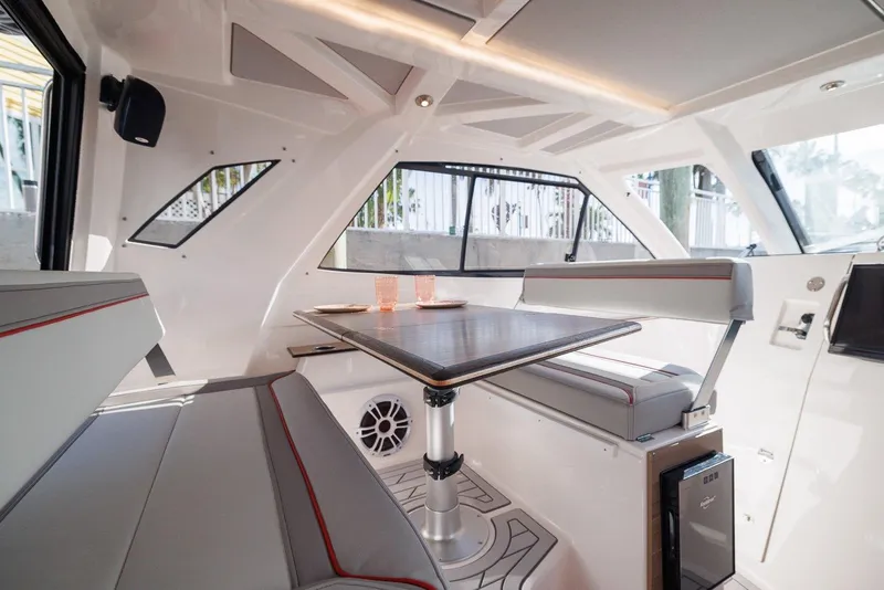 Slide: The Image of Interior of 2025 Solara S-310 SB boat with modern seating and table. - 7