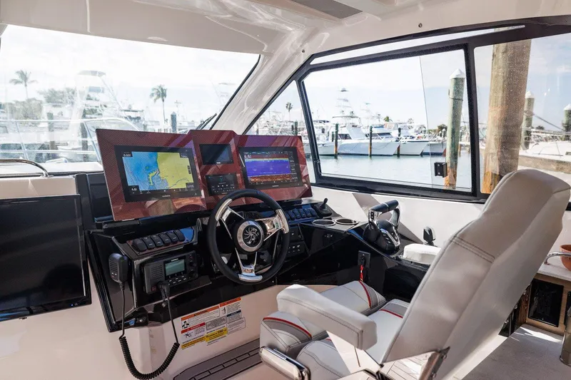 Slide: The Image of 2025 Solara S-310 SB yacht cockpit with advanced navigation systems and luxurious seating. - 8