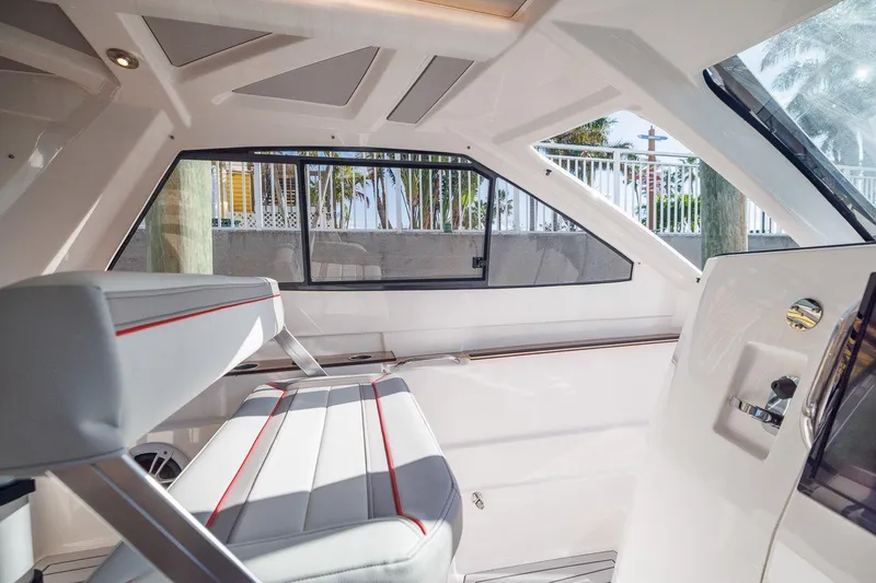 Slide: The Image of Interior of 2025 Solara S-310 SB boat with modern seating and large windows. - 9