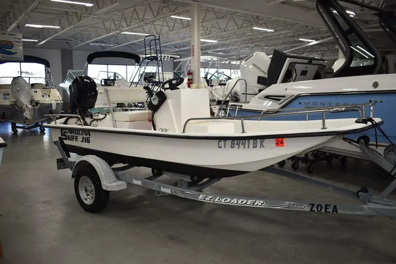 Slide: The Image of 2011 Carolina Skiff J16 boat on trailer in showroom. - 1