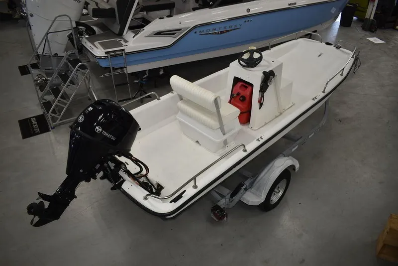 Slide: The Image of 2011 Carolina Skiff J16 boat on trailer with outboard motor in showroom. - 10