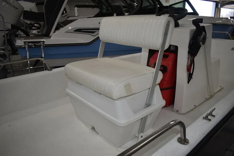 Slide: The Image of 2011 Carolina Skiff J16 boat interior with white seating and steering console. - 12