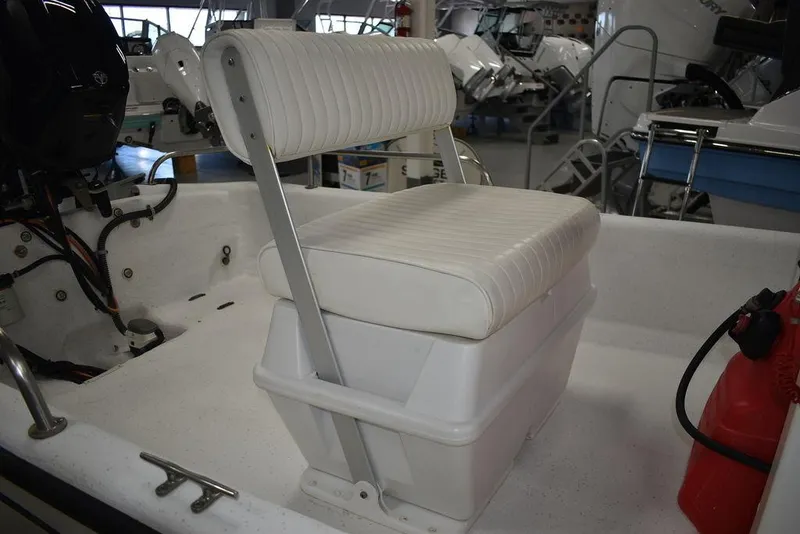 Slide: The Image of 2011 Carolina Skiff J16 boat interior with white cushioned seating and storage. - 14