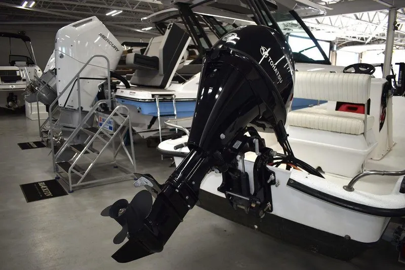 Slide: The Image of 2011 Carolina Skiff J16 boat with outboard motor in showroom. - 16